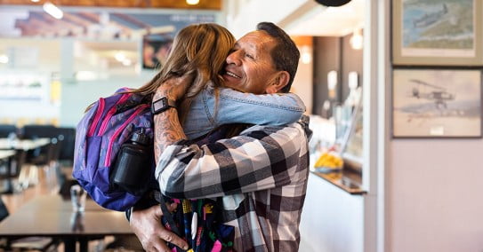 Air New Zealand girl hugging granddad