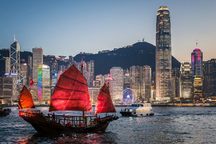 Junk boat sailing across Victoria Harbour, Hong Kong. 