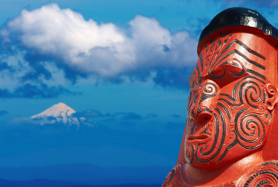 Māori carving and Mt Taranaki, New Zealand. 