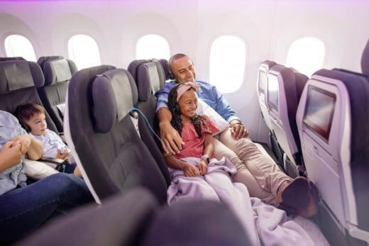 Father and daughter in Economy Skycouch.